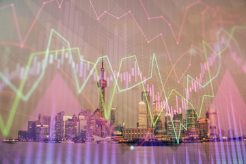 Forex chart on cityscape with tall buildings background multi exposure. Financial research concept.