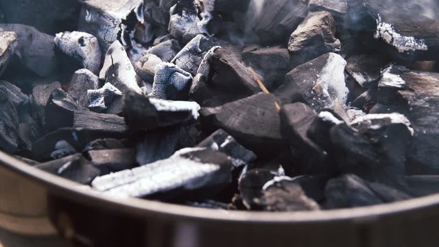 cooking, heat and fire concept - charcoal burning in brazier outdoors