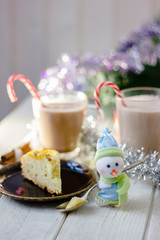 Christmas snowman holding spoon with christmas pie in hands.