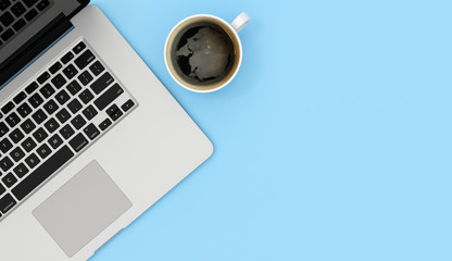 Obraz na płótnie Canvas Laptop and coffee mug copy space on blue table background, 3d rendering