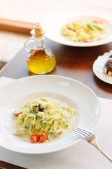 Traditional italian fettuccine pasta with pesto in italian restaurant.