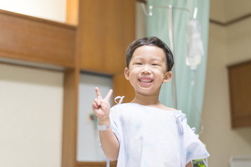 The patient boy is happy in the hospital, He has a cheerful heart.