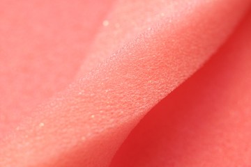 White and Pink artificial foam, foam texture on a light background.