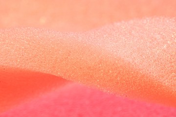 White and Pink artificial foam, foam texture on a light background.