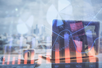 Stock market graph on background with desk and personal computer. Multi exposure. Concept of financial analysis.