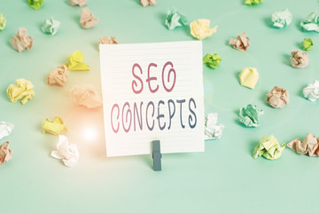 Conceptual hand writing showing Seo Concepts. Concept meaning a process of increasing the quality of website traffic Colored crumpled papers empty reminder blue floor clothespin