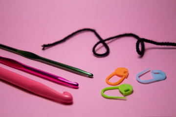 Crochet hooks. On a pink background. There is a place for text. Copy space.