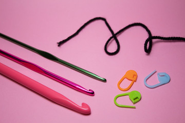 Crochet hooks. On a pink background. There is a place for text. Copy space.