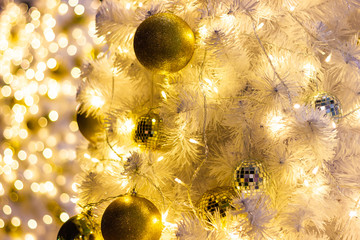 ball  gold color,  beautiful Christmas tree with decorations bokeh golden light background