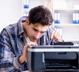 Hardware repairman repairing broken printer fax machine