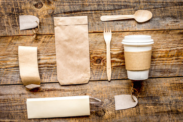 food delivery with paper bags and plastic cup on wooden table background top view mockup
