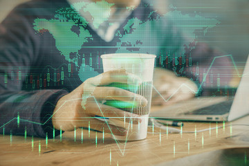Forex graph with businessman working on computer in office on background. Concept of hardworking. Closeup. Multi exposure.