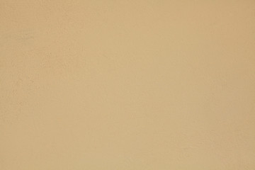 Beige or light-brown wall, texture, background. The building wall, painted with water-based paint. Pale (flat) surface in coffee color