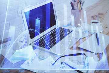 Forex market chart hologram and personal computer background. Double exposure. Concept of investment.