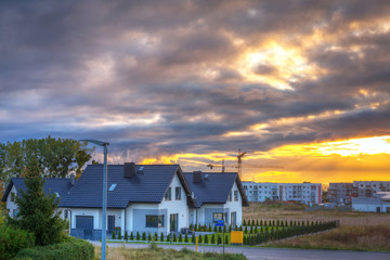 Fototapeta na wymiar Street with houses in Poland at sunrise