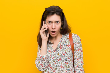 Young caucasian woman holding a phone