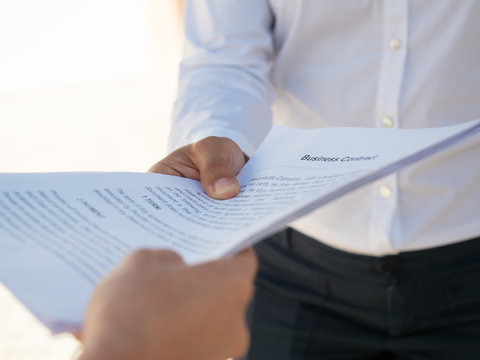 Businesswoman giving contract to partner for signing. Hands of business people holding documents. Deal or paperwork concept