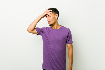 Young hispanic man forgetting something, slapping forehead with palm and closing eyes.