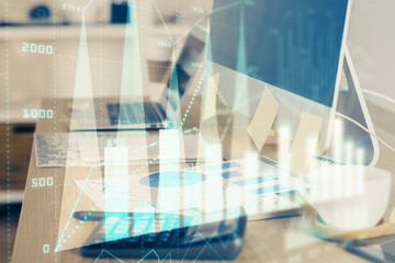 Financial chart drawing and table with computer on background. Double exposure. Concept of international markets.