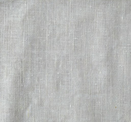 Dark white canvas with fold marks. Abstract background of crumpled cheesecloth. Close up  