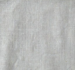 Fototapeta premium Dark white canvas with fold marks. Abstract background of crumpled cheesecloth. Close up 