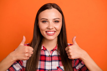 Close-up portrait of her she nice attractive lovely cheerful cheery content straight-haired girl showing double thumbup isolated on bright vivid shine vibrant orange color background