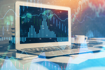 Financial market graph hologram and personal computer on background. Multi exposure. Concept of forex.