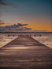 Fototapeta na wymiar Wooden Lake pier at Sunset