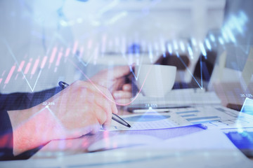 Double exposure hands with stock market chart.