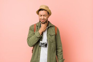 Young filipino traveler man suffers pain in throat due a virus or infection.