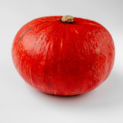 Fresh red single hokkaido pumpkin on white background. Closeup