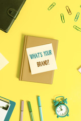 Word writing text What S Your Brand Question. Business photo showcasing Define Individual trademark Identify Company Flat lay above table with copy space paper clips clock and pencils