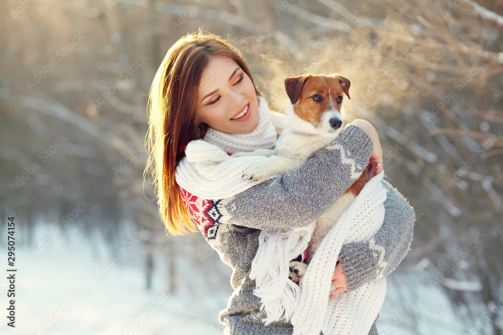 Wall mural jack russell terrier dog with owner in the winter outdoors