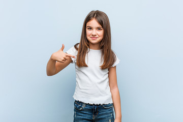 Cute girl person pointing by hand to a shirt copy space, proud and confident