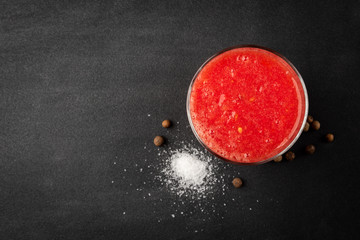 Obraz na płótnie Canvas Tomato juice on black background.