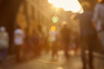 blurred background. a lot of people walking on a city street.