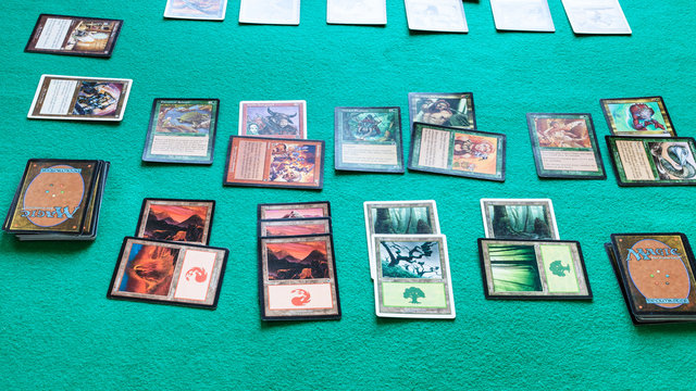 MOSCOW, RUSSIA - APRIL 2, 2019: cards of Magic: The Gathering board game on green baize table . Magic was the first trading card game, it was released in 1993 by Wizards of the Coast