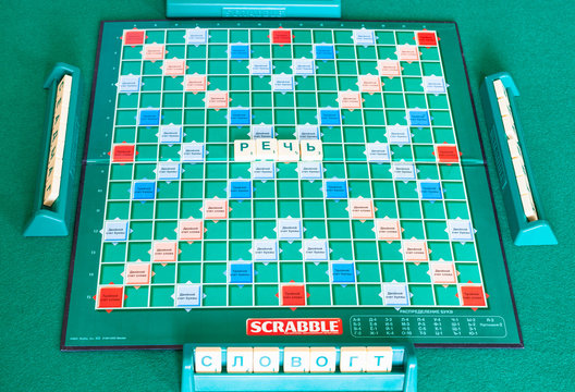 MOSCOW, RUSSIA - APRIL 3, 2019: gameplay in russian edition of Scrabble board game on green table. Scrabble is a word game, it was designed by Alfred Mosher Butts and first published in 1938