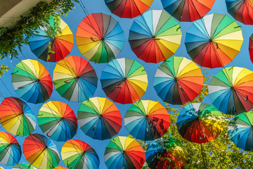 Fototapeta na wymiar The street is decorated with beautiful colorful umbrellas, the sun is shining Odessa, Ukraine