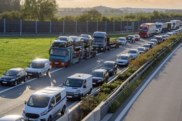 Traffic jam with emergency lane (german rettungsgasse) to rush hour on the highway, transportation...
