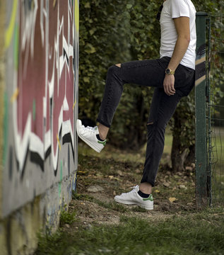 Young Man Wearing Adidas Stan Smith Shoes In The Street