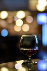 Whiskey in glass for adult on counter bar at to night.