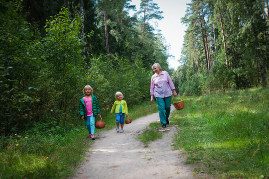 grandmother with kids with baskets coming from the forest