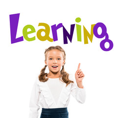 happy kid pointing with finger at learning lettering on white