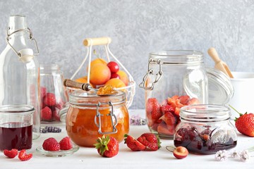 Fototapeta na wymiar Apricot lavender marmalade in a glass jar on a rustic wooden table