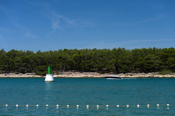 Obraz premium Big buoy in the lake and the boat