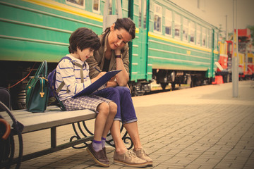 Mother and son on the railway station