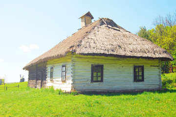 Fototapeta na wymiar White village house with thatched roof