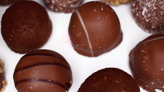 Bonbon Chocolates Bonbons footage video on slow motion rotating rolling plate