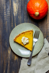 Pumpkin pie on a wooden background. Traditional recipe.
